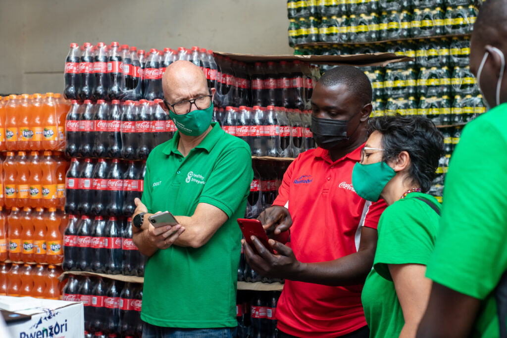 Health entrepreneurs learning from a Coca-Cola bottler about supply chain